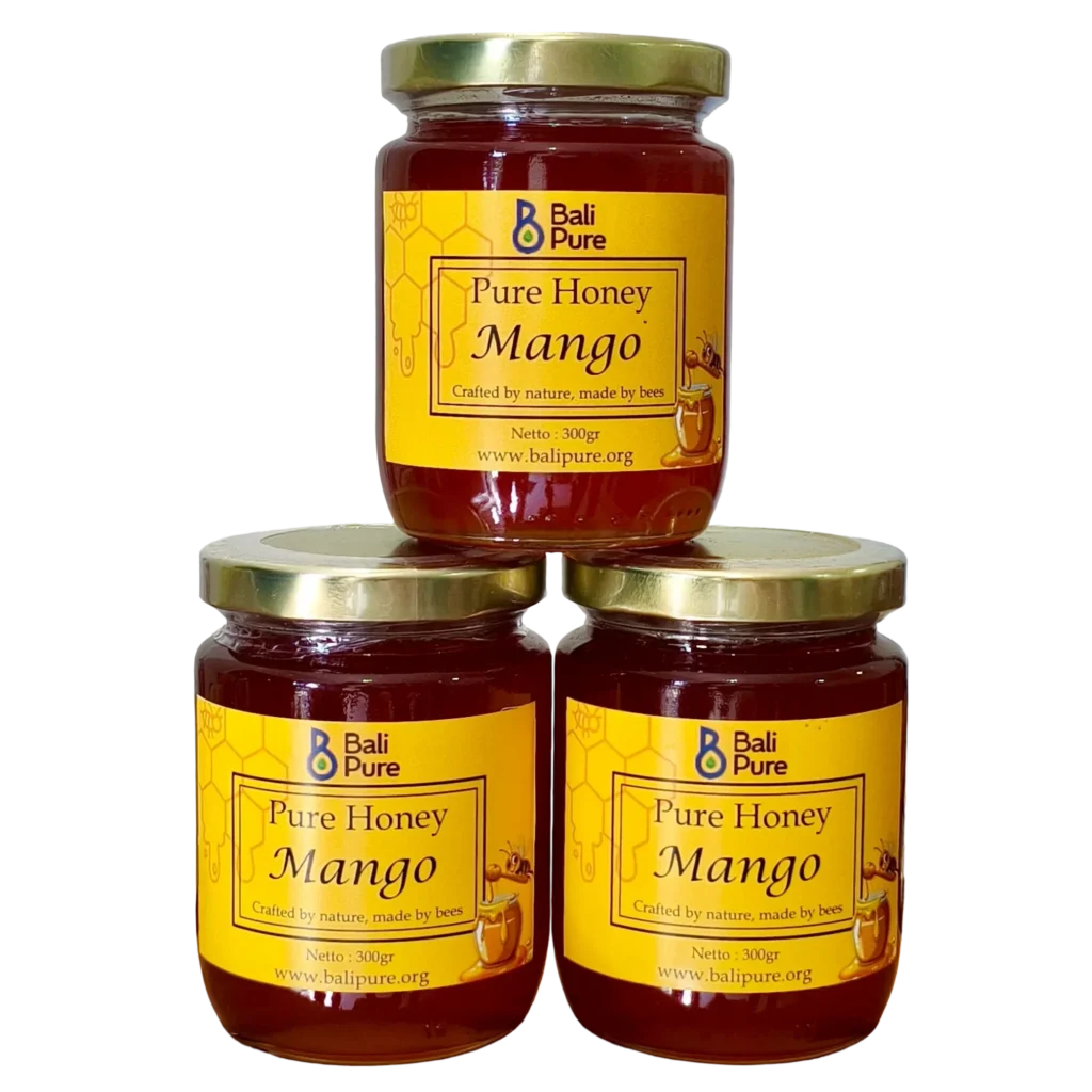 Three 300g jars of Bali Pure Mango Honey stacked on each other
